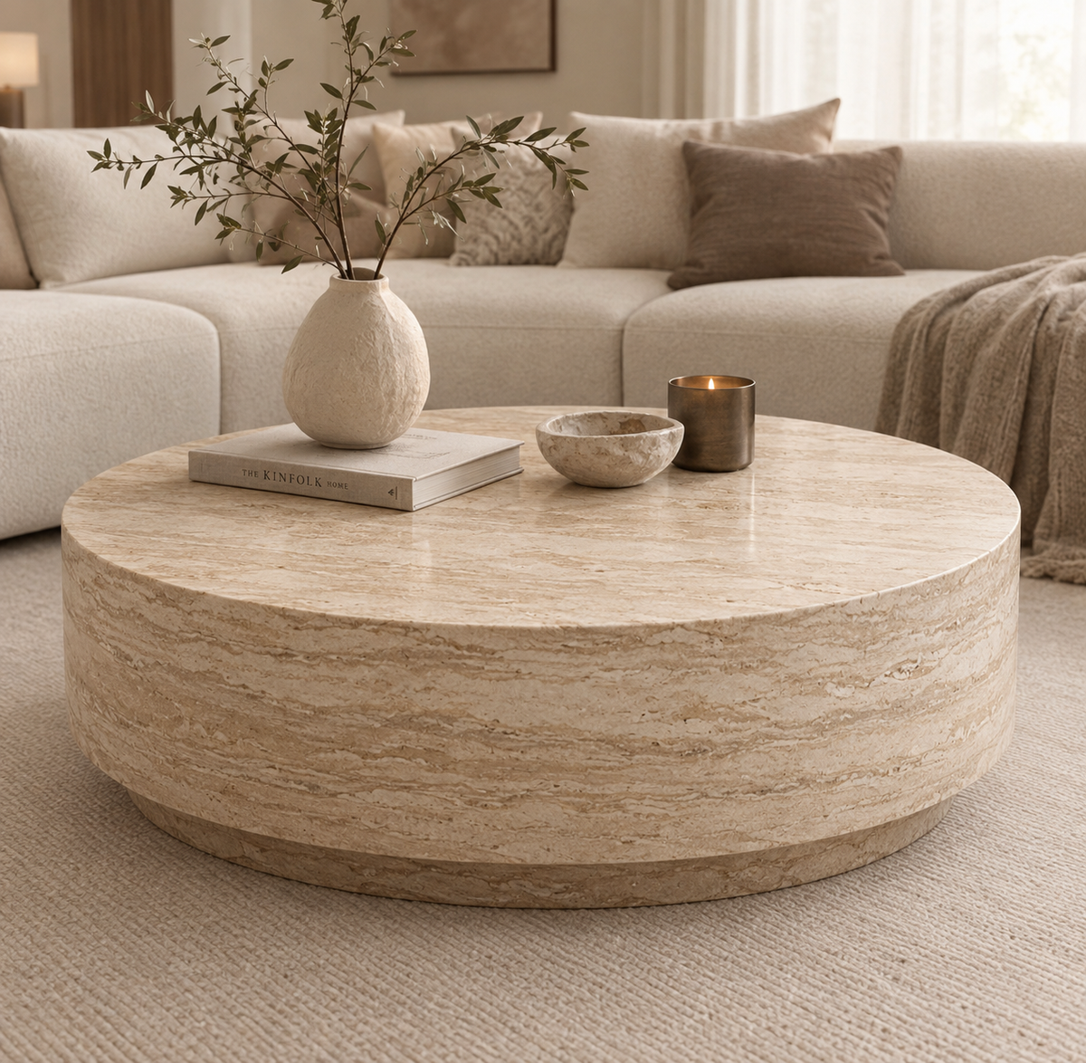 Troy travertine drum coffee table styled with vase and candles
