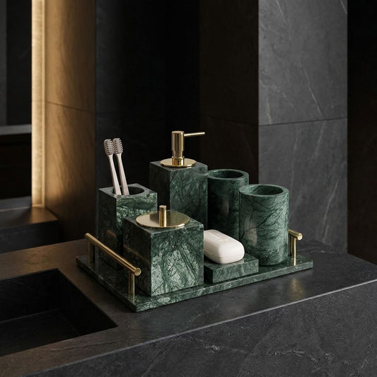 Knidos emerald green marble bathroom accessory set with gold hardware on a dark counter