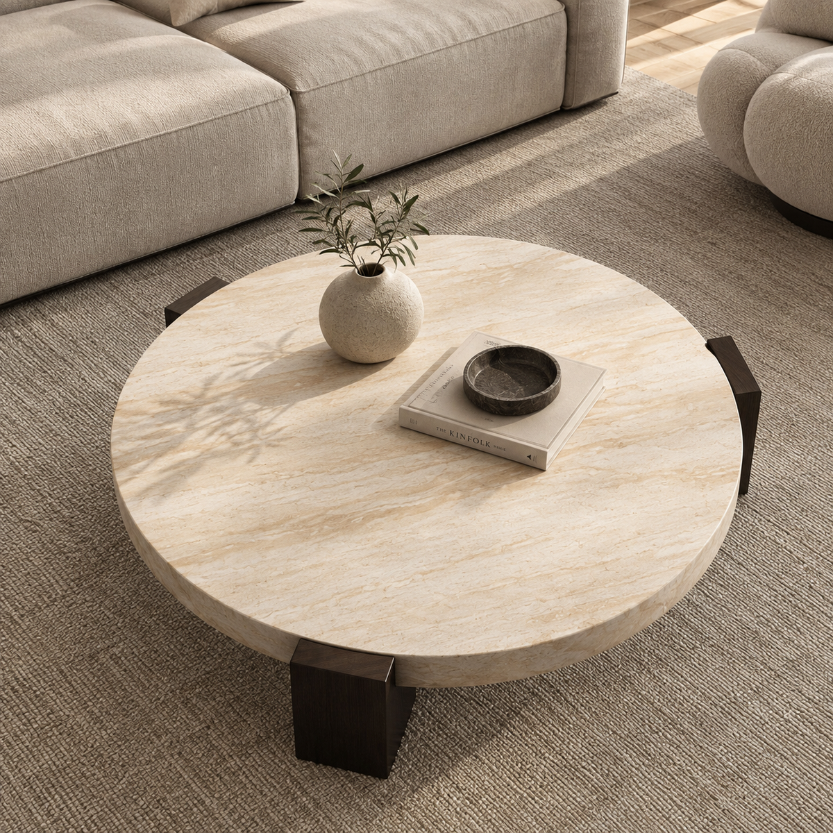 Lycia travertine coffee table with vase and book, overhead view