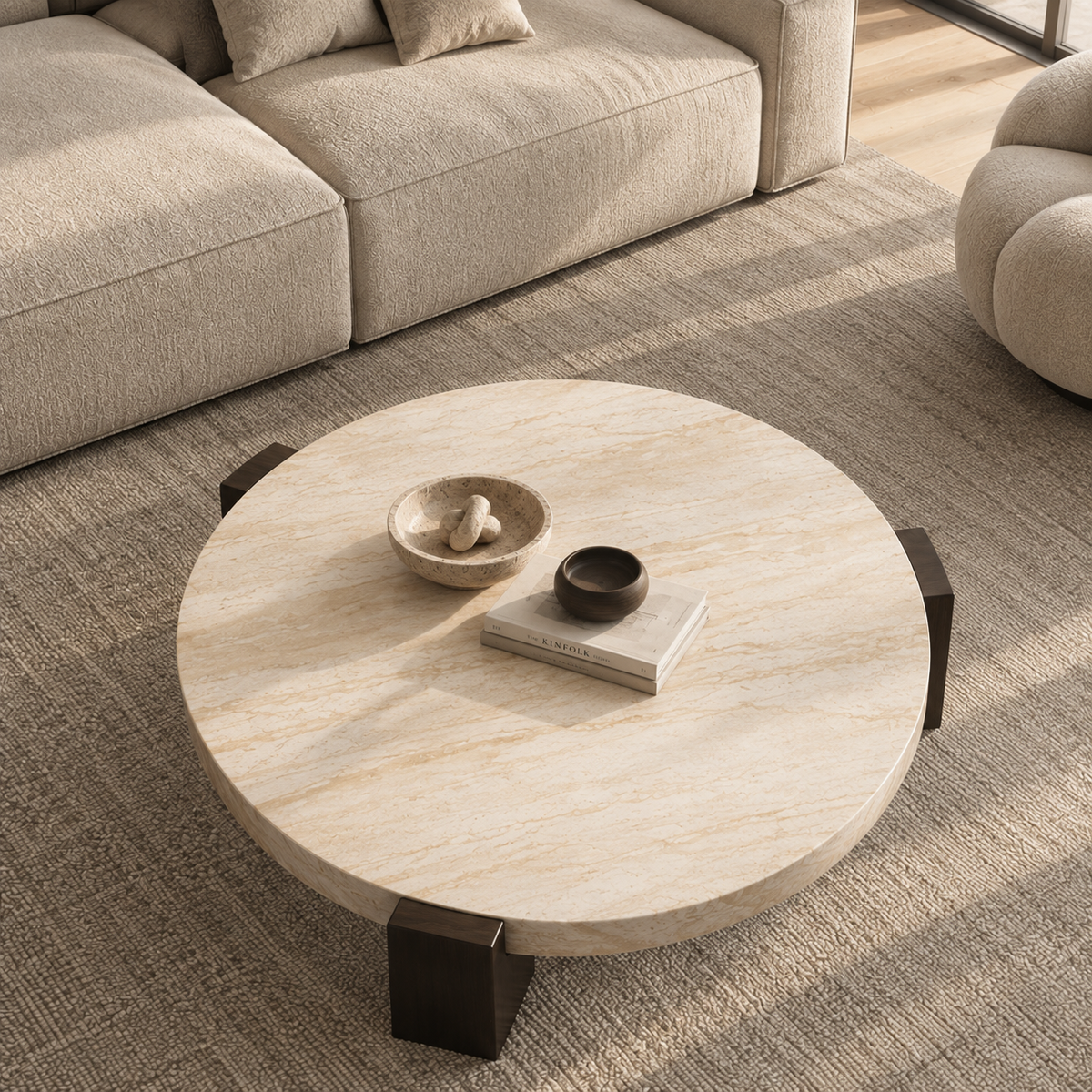 Lycia round travertine coffee table on a grey rug